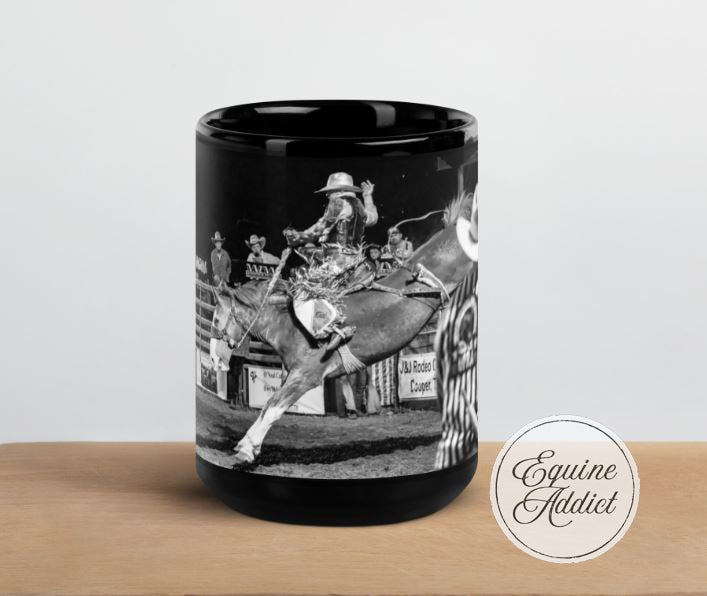 black ceramic mug with a cowboy riding a bucking horse