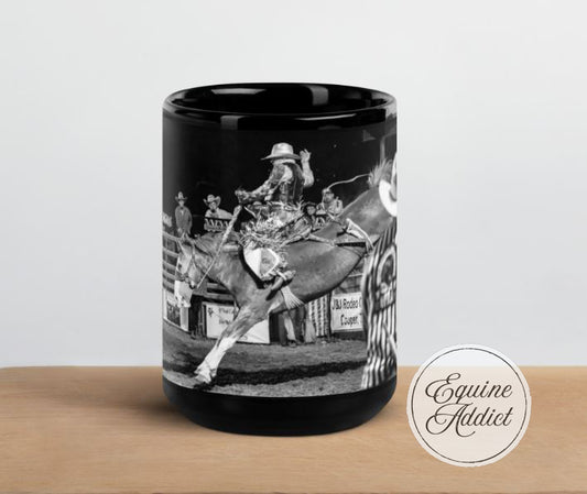 black ceramic mug with a cowboy riding a bucking horse
