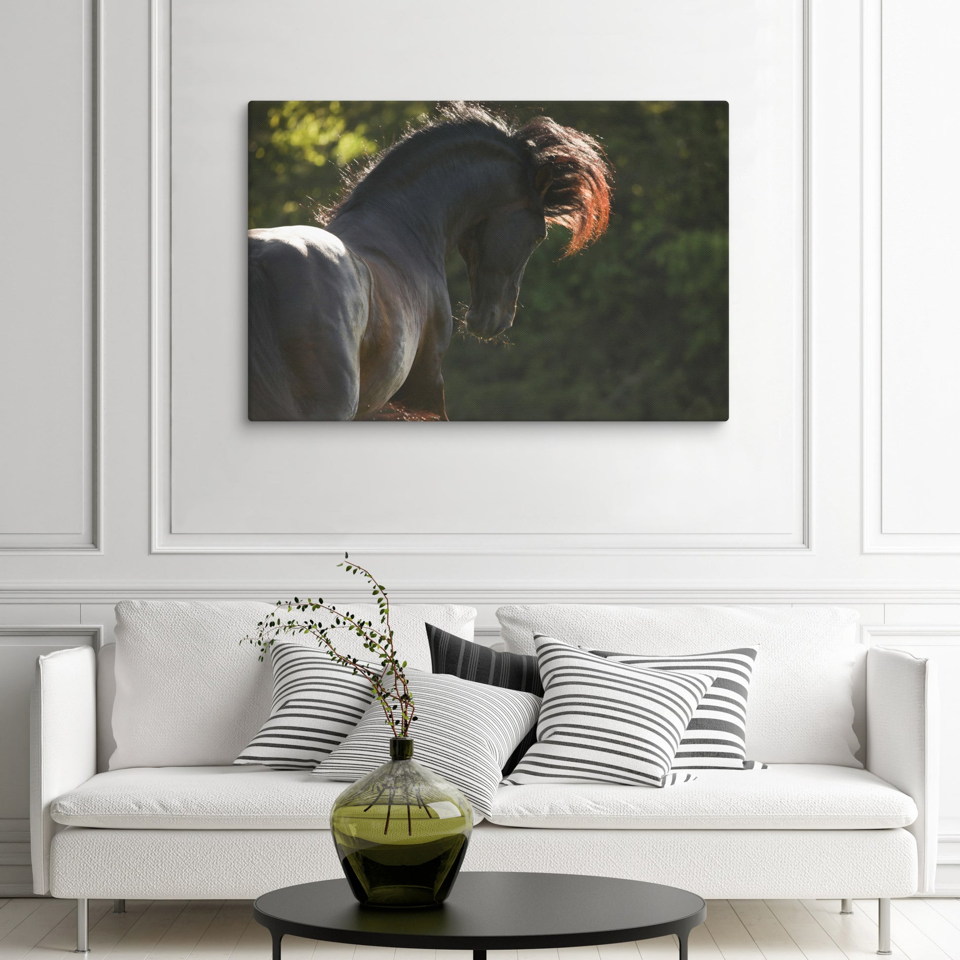 Living room with a white sofa, decorative pillows, and a vase on a coffee table, featuring a canvas print of a horse on the wall.