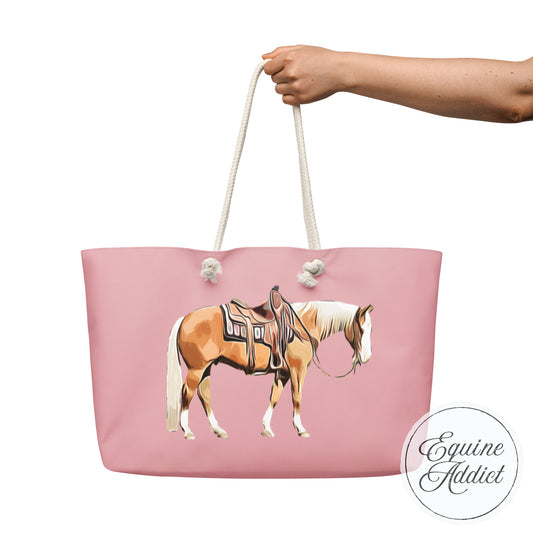 cartoon drawing of a palomino horse on a pink weekender tote bag with rope handles